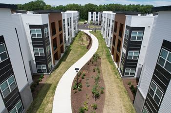 an aerial view of a group of town houses with a sidewalk